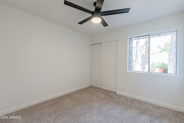 unfurnished room featuring carpet and ceiling fan