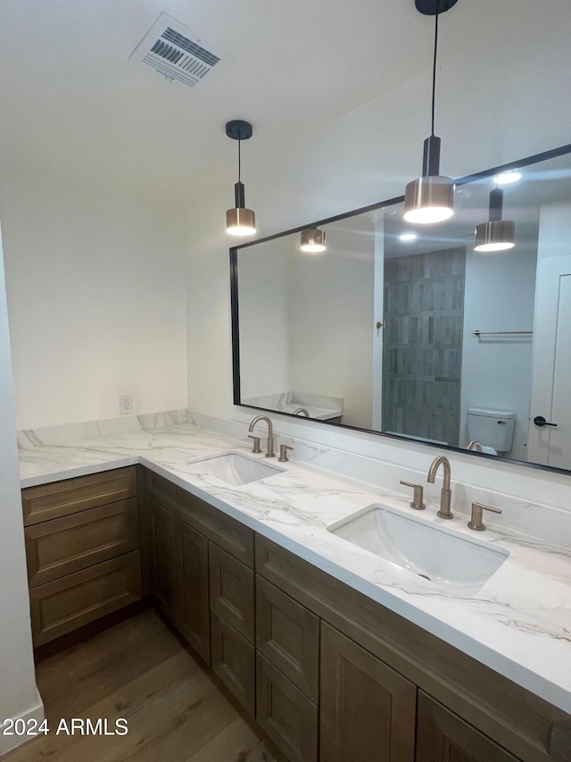 bathroom featuring walk in shower, toilet, vanity, and hardwood / wood-style flooring