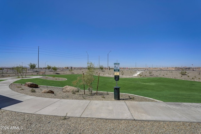view of home's community with a yard