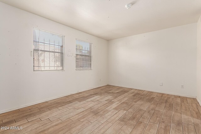 spare room with light wood-type flooring