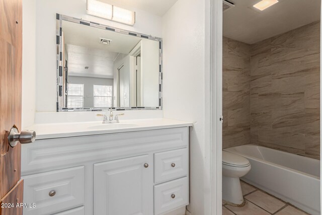 bathroom with vanity, toilet, and tile patterned flooring