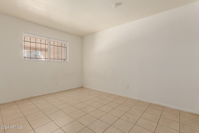 empty room featuring light tile patterned floors