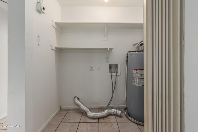 laundry area featuring light tile patterned floors, electric water heater, and electric dryer hookup