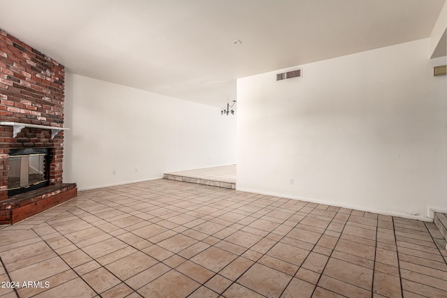 unfurnished living room with a fireplace and light tile patterned floors