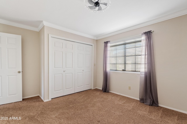 unfurnished bedroom with ornamental molding, light colored carpet, and a closet