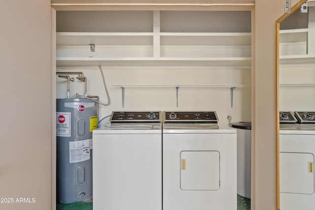 laundry room featuring electric water heater and separate washer and dryer