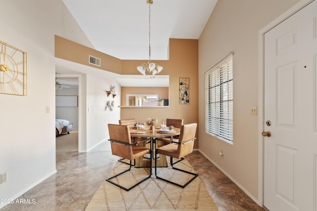 dining space featuring ceiling fan with notable chandelier