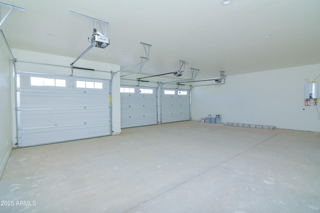 garage featuring tankless water heater and a garage door opener