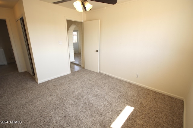 unfurnished bedroom featuring carpet and ceiling fan