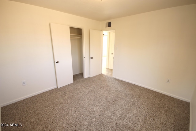 unfurnished bedroom with carpet and a closet