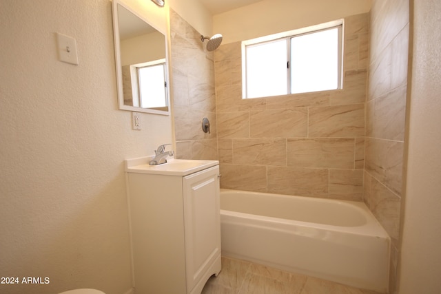 bathroom with vanity and tiled shower / bath combo