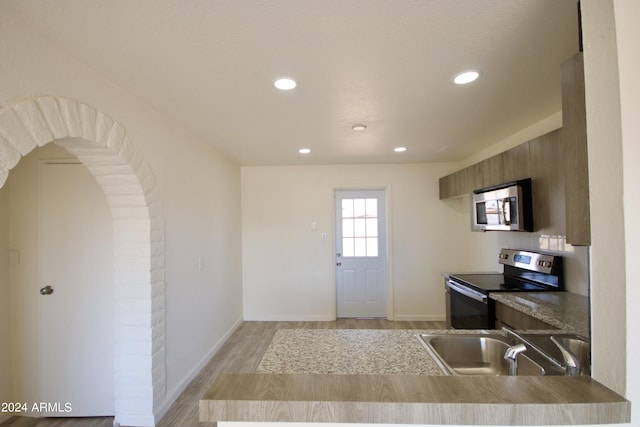 kitchen featuring sink, light hardwood / wood-style flooring, and stainless steel appliances