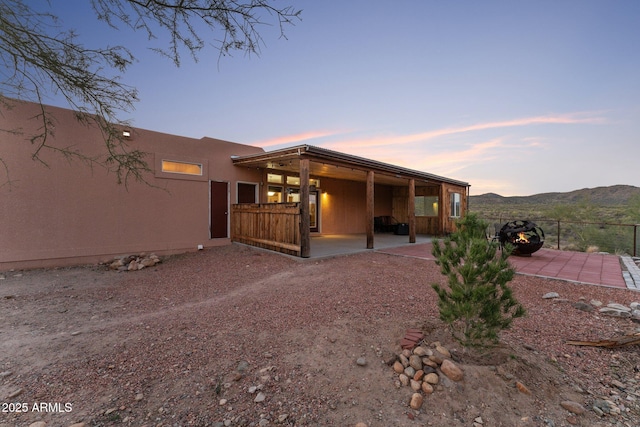 3874 Pura Vida Trl, Wickenburg, AZ 85390 - rear view of house featuring fence, a mountain view, and a patio area