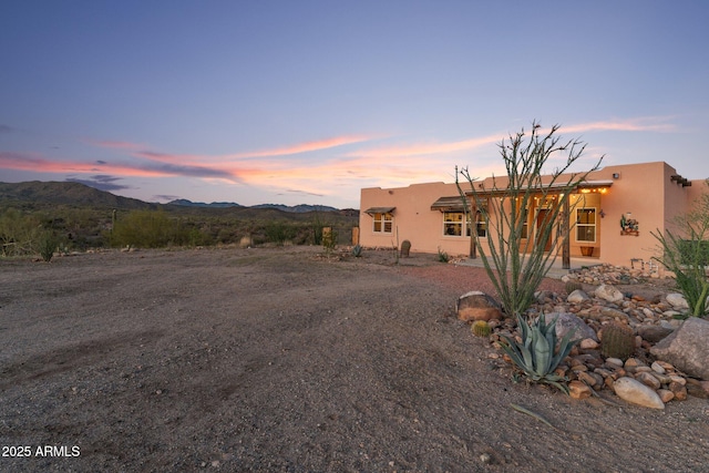 3874 Pura Vida Trl, Wickenburg, AZ 85390 - rear view of house featuring stucco siding and a mountain view