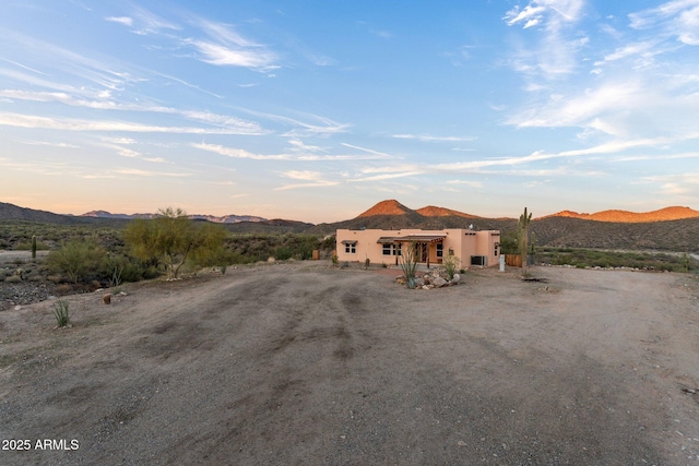3874 Pura Vida Trl, Wickenburg, AZ 85390 - adobe home with stucco siding and a mountain view