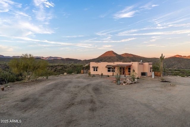 3874 Pura Vida Trl, Wickenburg, AZ 85390 - view of front facade with stucco siding and a mountain view