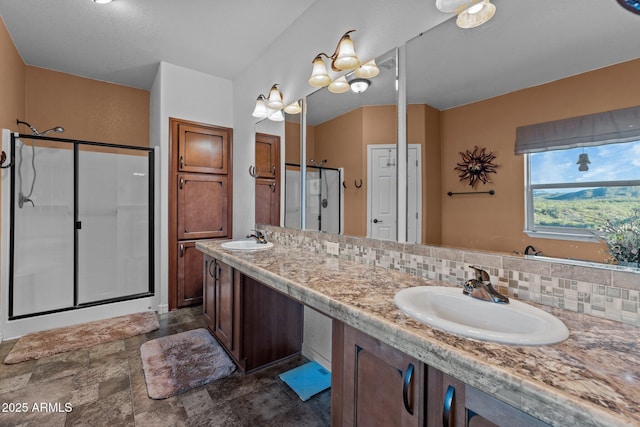 3874 Pura Vida Trl, Wickenburg, AZ 85390 - bathroom featuring a shower stall, tasteful backsplash, and a sink