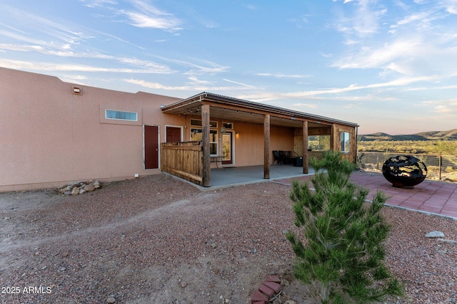 3874 Pura Vida Trl, Wickenburg, AZ 85390 - exterior space with fence, stucco siding, and a patio area