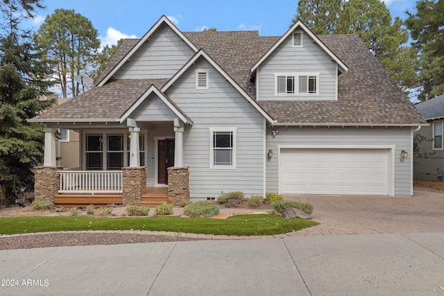 craftsman house featuring covered porch and a garage