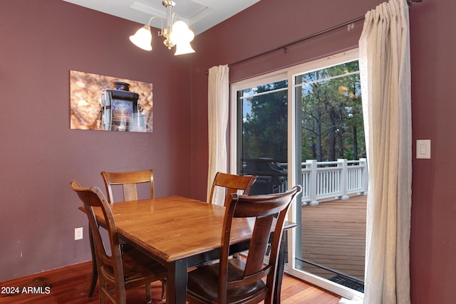 dining room with an inviting chandelier and hardwood / wood-style flooring