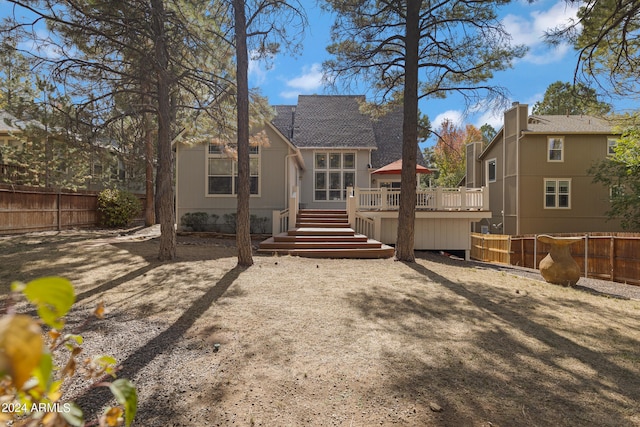 back of house featuring a deck