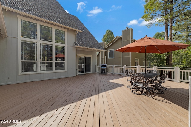 wooden terrace with a grill