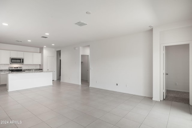 unfurnished living room with light tile patterned floors