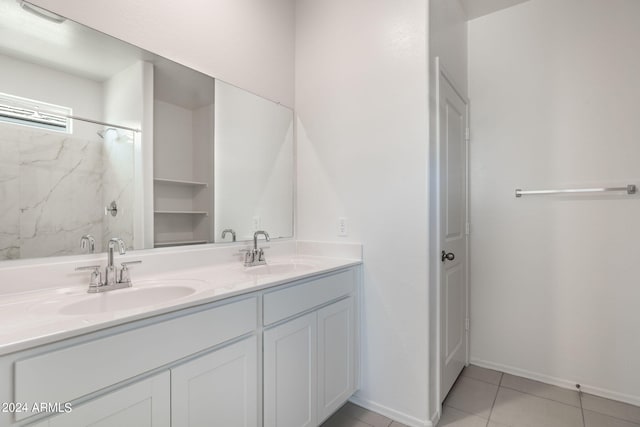 bathroom featuring tile patterned floors, vanity, and walk in shower