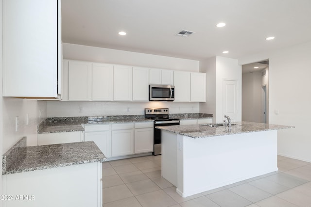 kitchen featuring white cabinets, sink, stainless steel appliances, and an island with sink