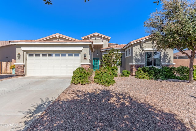 view of front of home with driveway, a tile roof, an attached garage, fence, and stucco siding