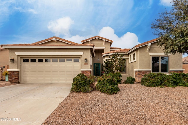 view of front of home featuring an attached garage, stone siding, a tiled roof, driveway, and stucco siding