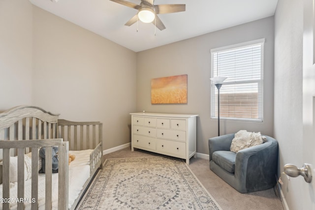 1281 W Highland Rd, San Tan Valley, AZ 85143 - bedroom featuring light colored carpet, baseboards, a nursery area, and ceiling fan