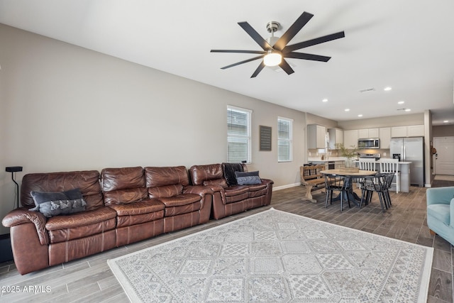 1281 W Highland Rd, San Tan Valley, AZ 85143 - living room with wood tiled floors, a ceiling fan, recessed lighting, and baseboards