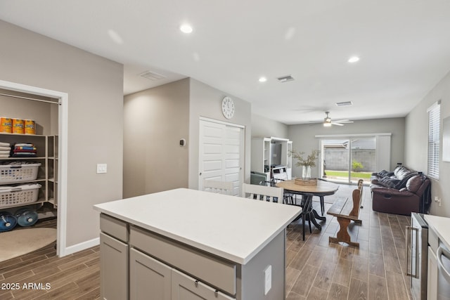 1281 W Highland Rd, San Tan Valley, AZ 85143 - kitchen featuring open floor plan, wood finish floors, light countertops, a kitchen island, and a ceiling fan