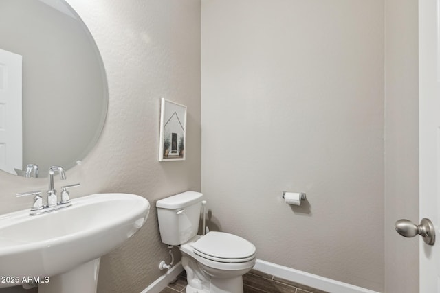 1281 W Highland Rd, San Tan Valley, AZ 85143 - bathroom featuring a sink, baseboards, toilet, and wood finish floors