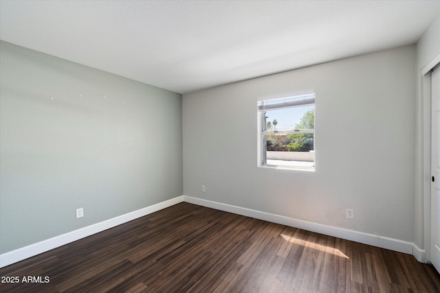 1505 N Center St Unit 218, Mesa, AZ 85201 - spare room with baseboards and dark wood-type flooring