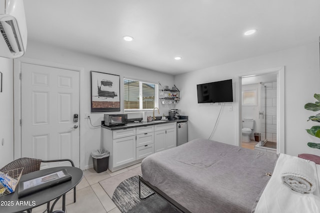 6943 E Granada Rd, Scottsdale, AZ 85257 - bedroom with a sink, a wall mounted air conditioner, light tile patterned floors, recessed lighting, and connected bathroom
