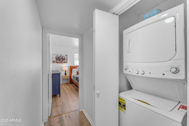 6943 E Granada Rd, Scottsdale, AZ 85257 - laundry room with estacked washer and dryer and light wood-style floors