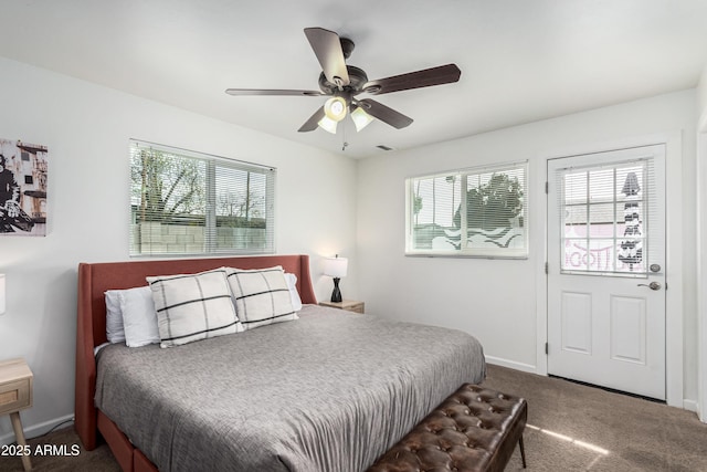 carpeted bedroom featuring ceiling fan, visible vents, and baseboards