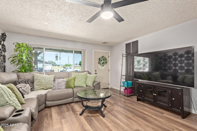 13614 N 33rd Ave, Phoenix, AZ 85029 - living area with light wood-type flooring, a textured ceiling, and ceiling fan