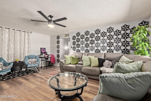 13614 N 33rd Ave, Phoenix, AZ 85029 - living area featuring a textured ceiling, a ceiling fan, and wood finished floors