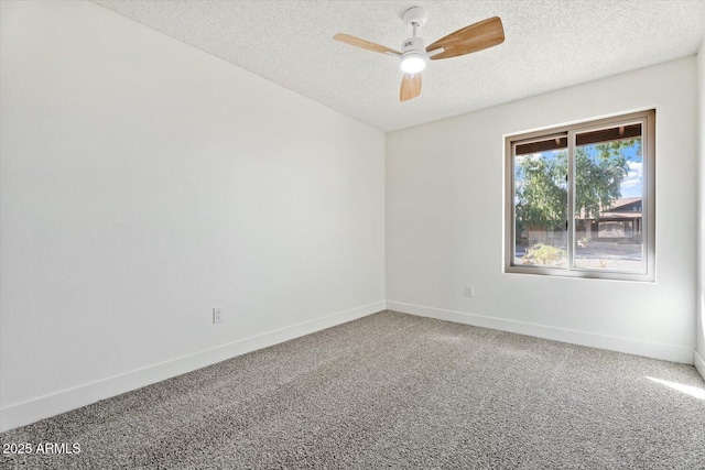 unfurnished room with a textured ceiling, carpet, and baseboards