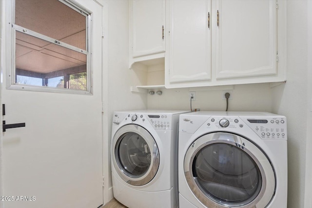 washroom with cabinet space and independent washer and dryer