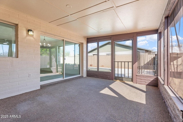 unfurnished sunroom with a chandelier