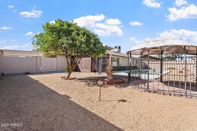 view of yard with a fenced in pool and fence