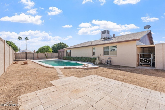 view of swimming pool with a patio area, a fenced in pool, a diving board, and cooling unit