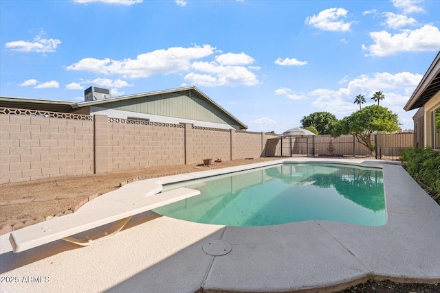 view of pool featuring a diving board, a patio area, a fenced backyard, and a fenced in pool