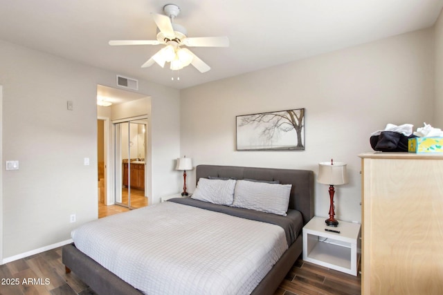 bedroom featuring visible vents, ensuite bathroom, dark wood-type flooring, a ceiling fan, and baseboards