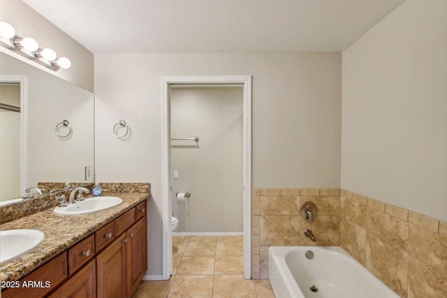 bathroom with double vanity, toilet, a sink, a bath, and tile patterned floors