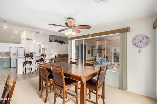 dining space featuring light carpet